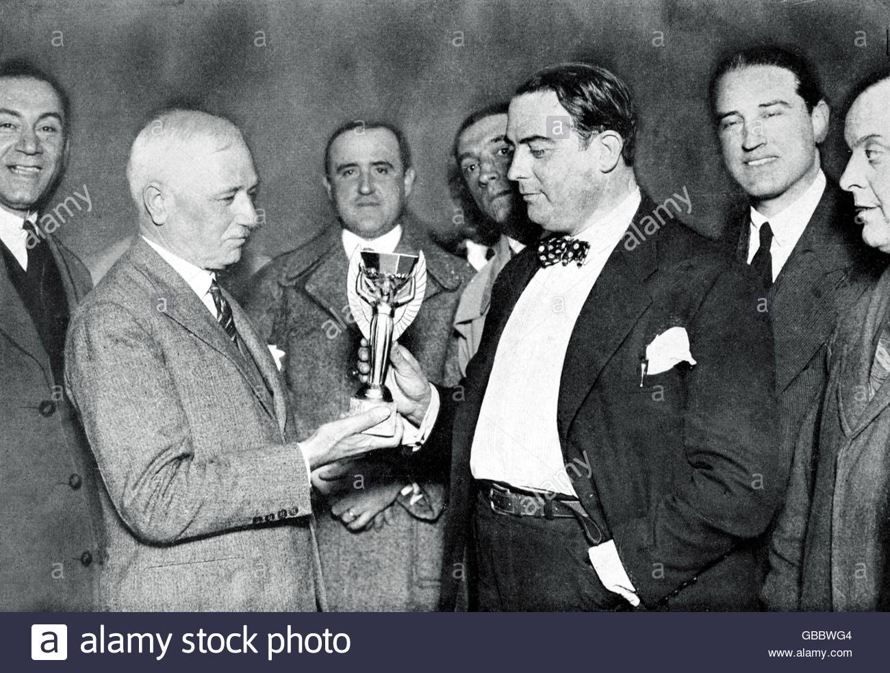 17-56-41-l-r-fifa-president-jules-rimet-presents-the-world-cup-to-dr-paul-jude-GBBWG4
